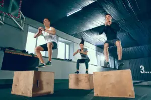 Man and woman doing a box jump exercise