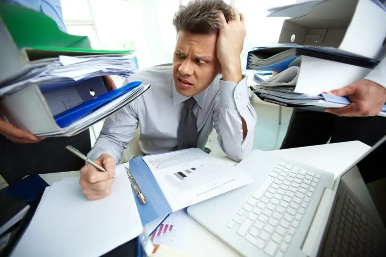 busy and overwhelmed employee at his desk