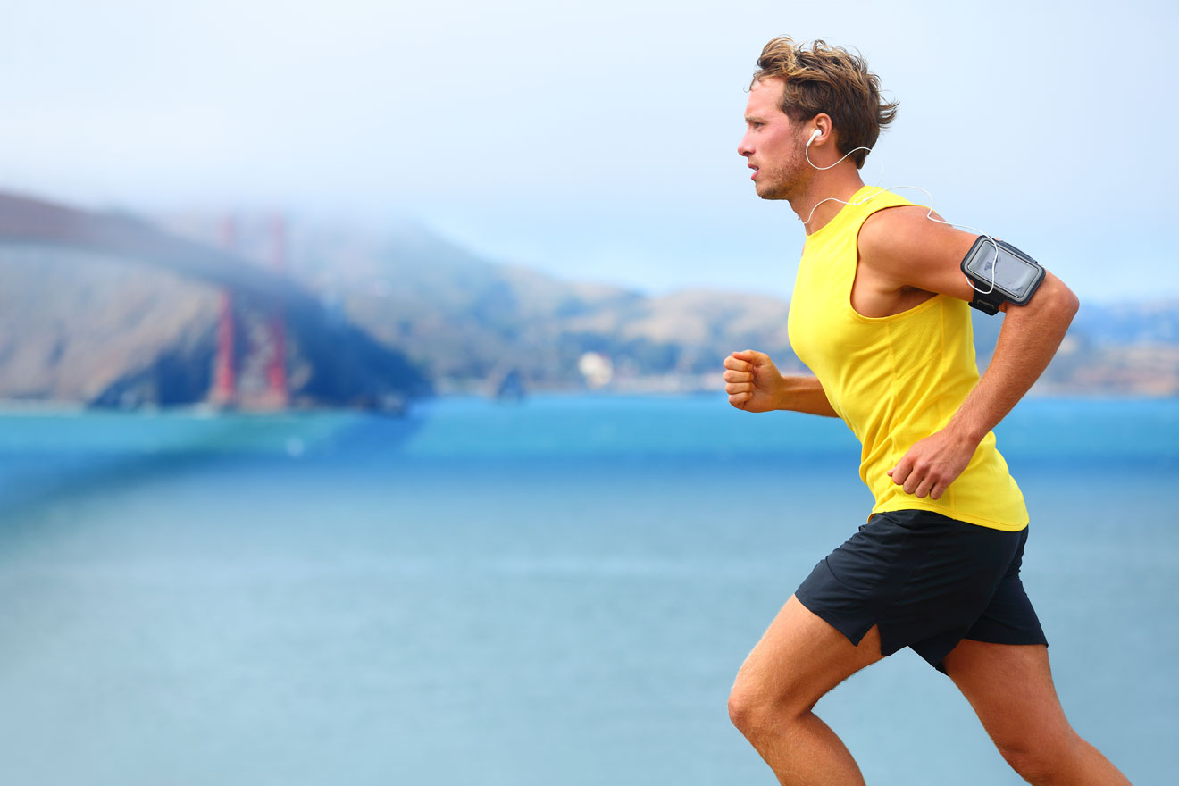 Man with yellow t-shirt running outside