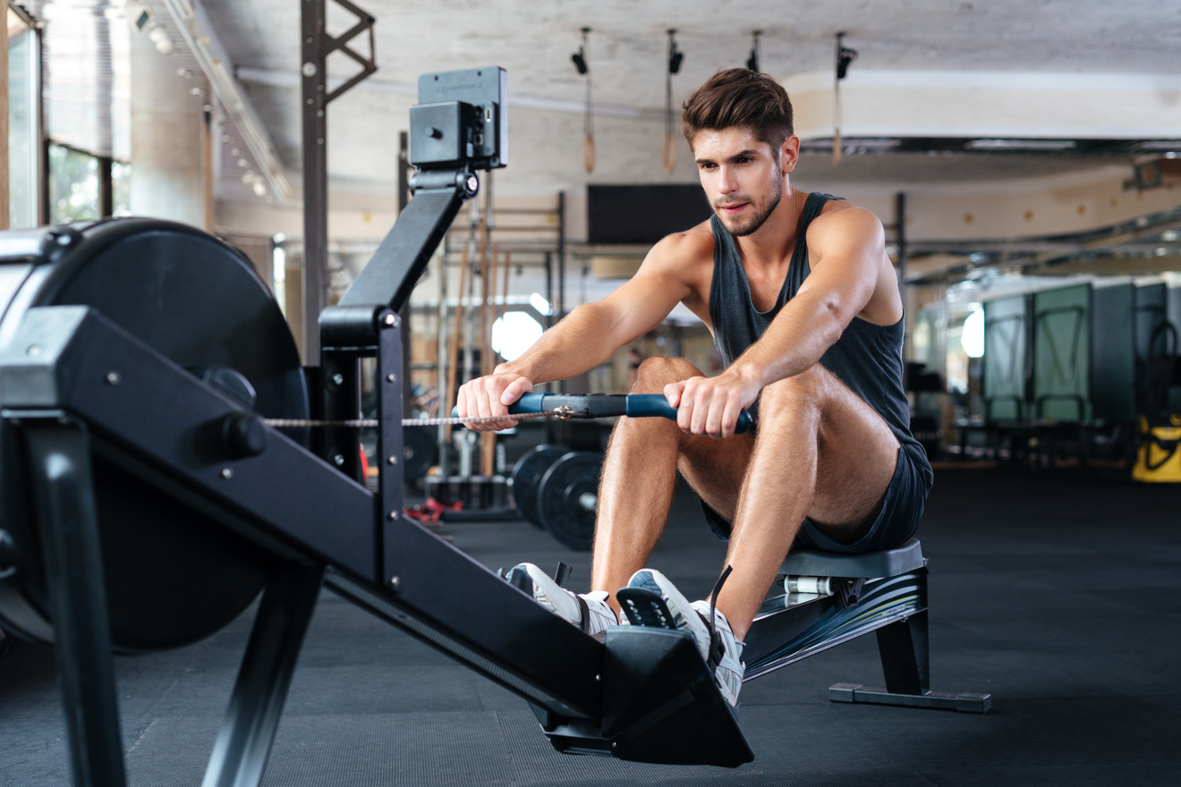 man using rowing machine in the gym