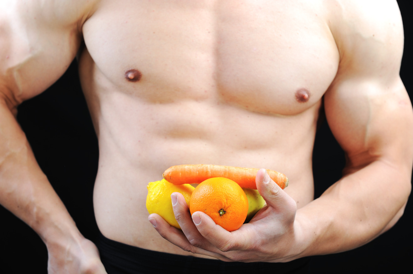 muscular man holding fruits