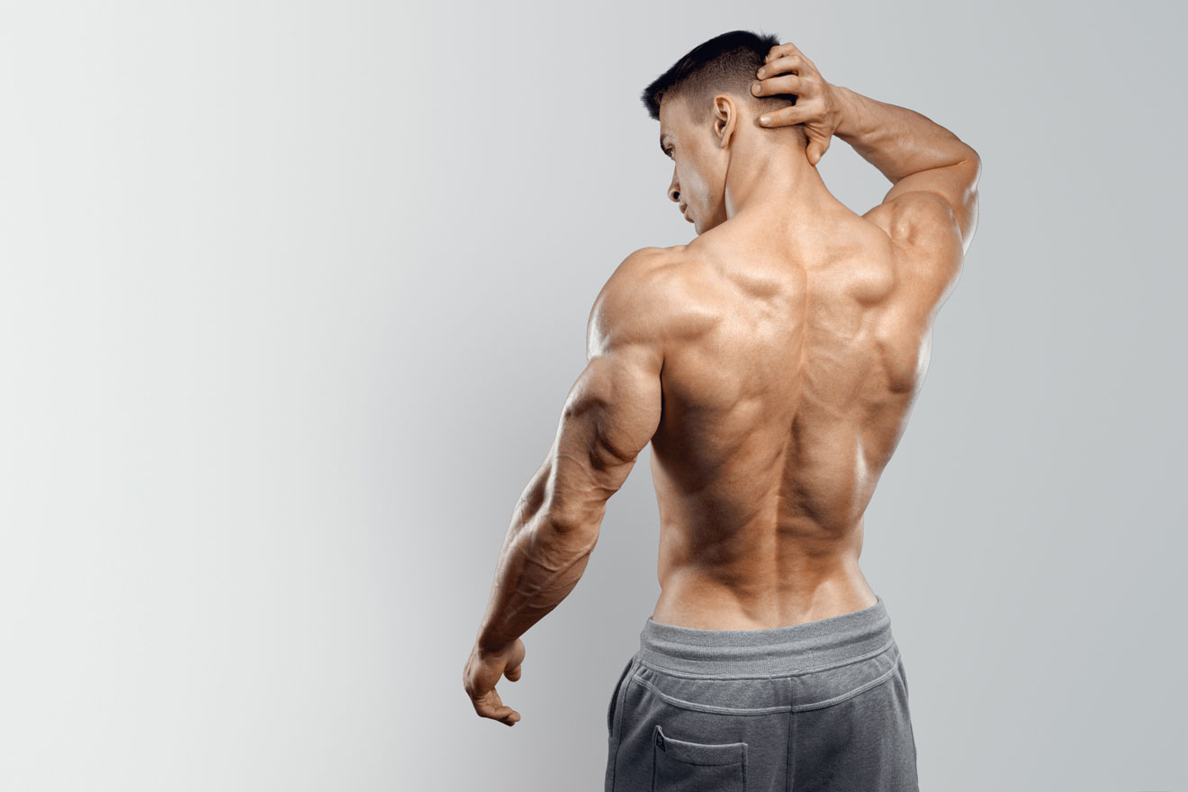 Muscular man holding back of neck