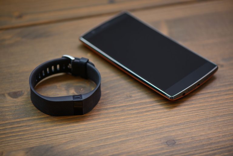 Smartphone and fitness band on a table