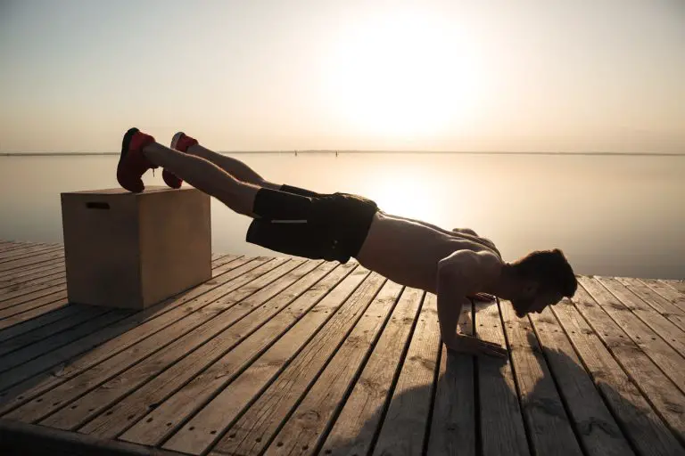 man doing decline push up