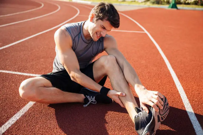 man with sore muscles after running