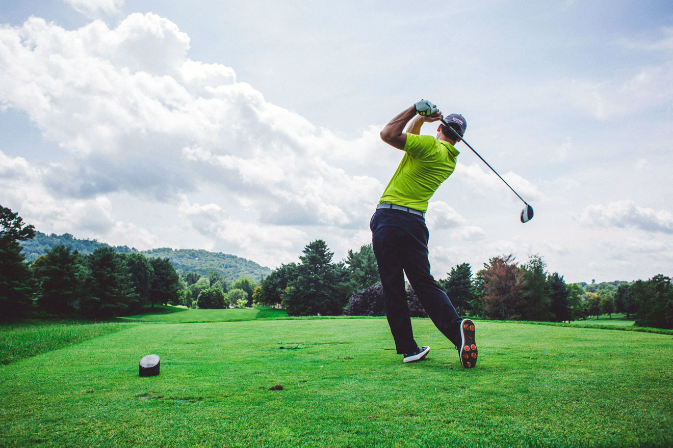 Golfer on a golf course swinging